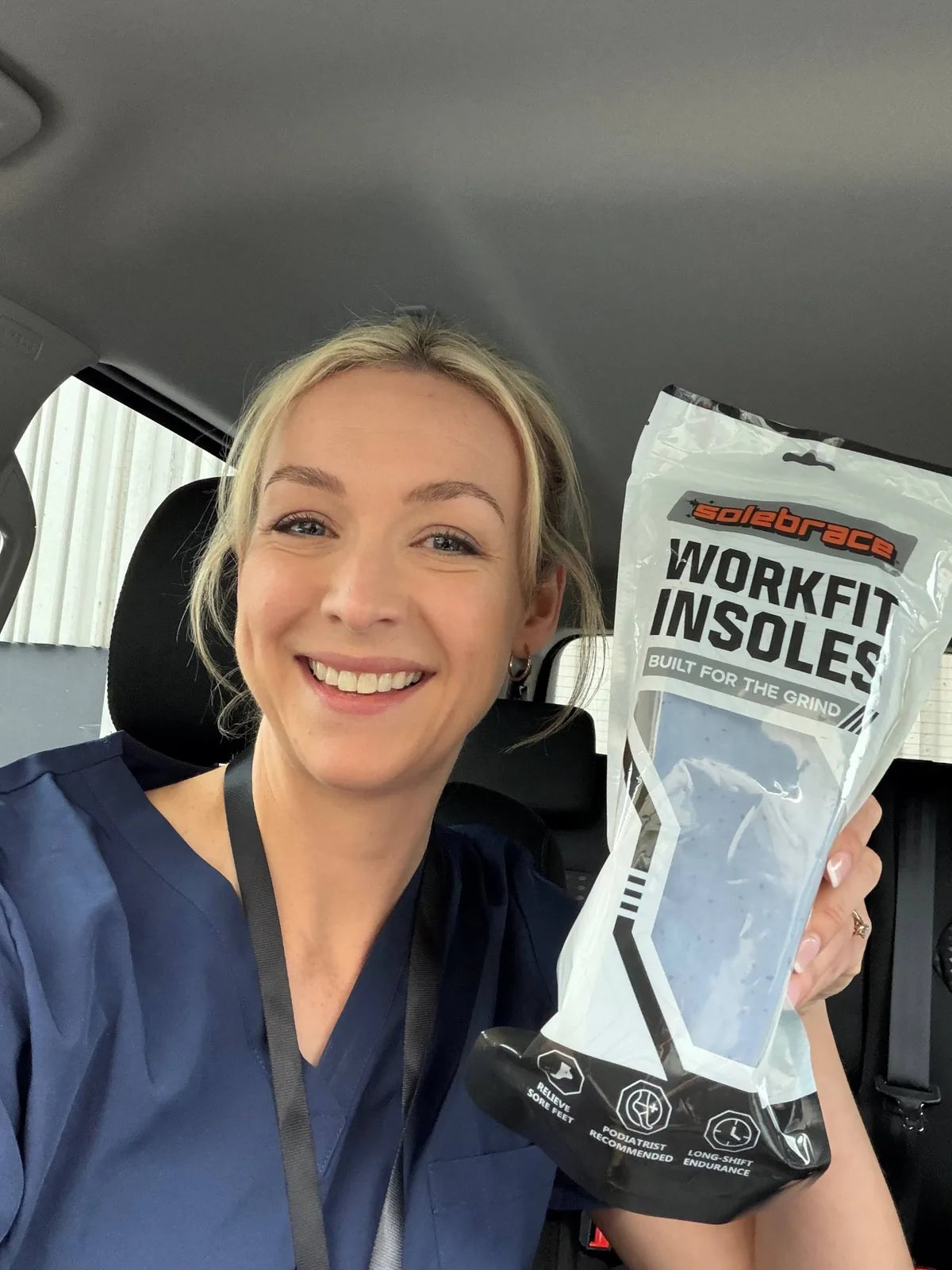 Nurse holding SoleBrace WorkFit insoles