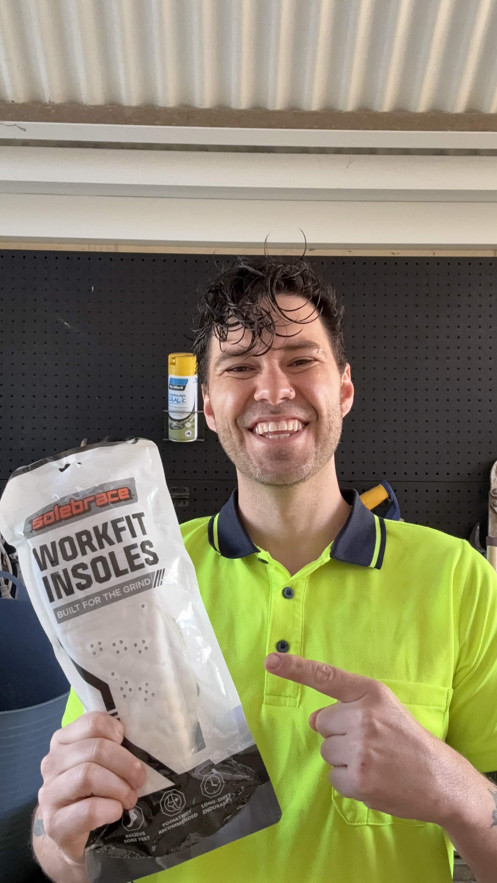 Worker holding a WorkFit Insoles pack