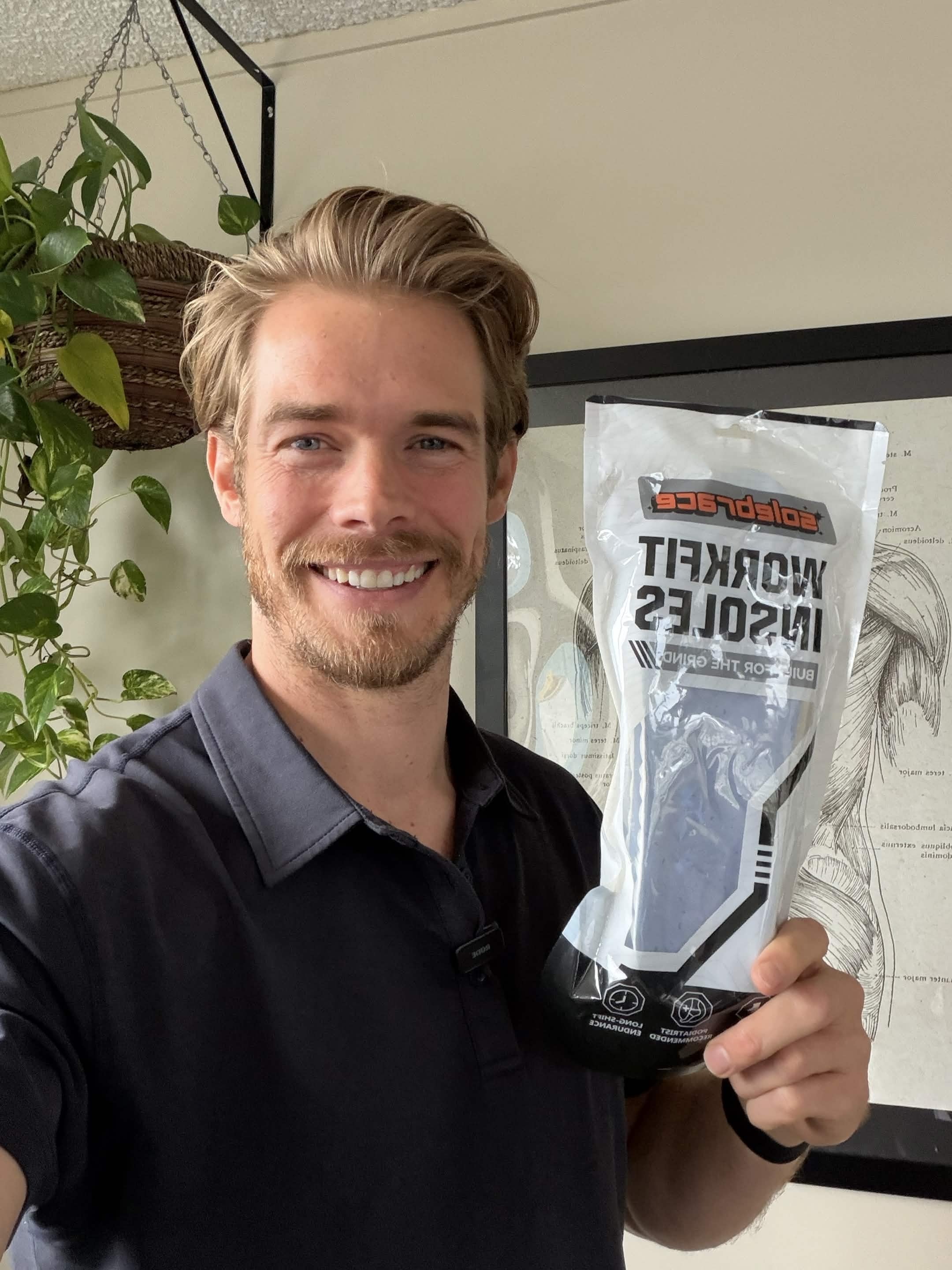 Worker holding a WorkFit Insoles pack