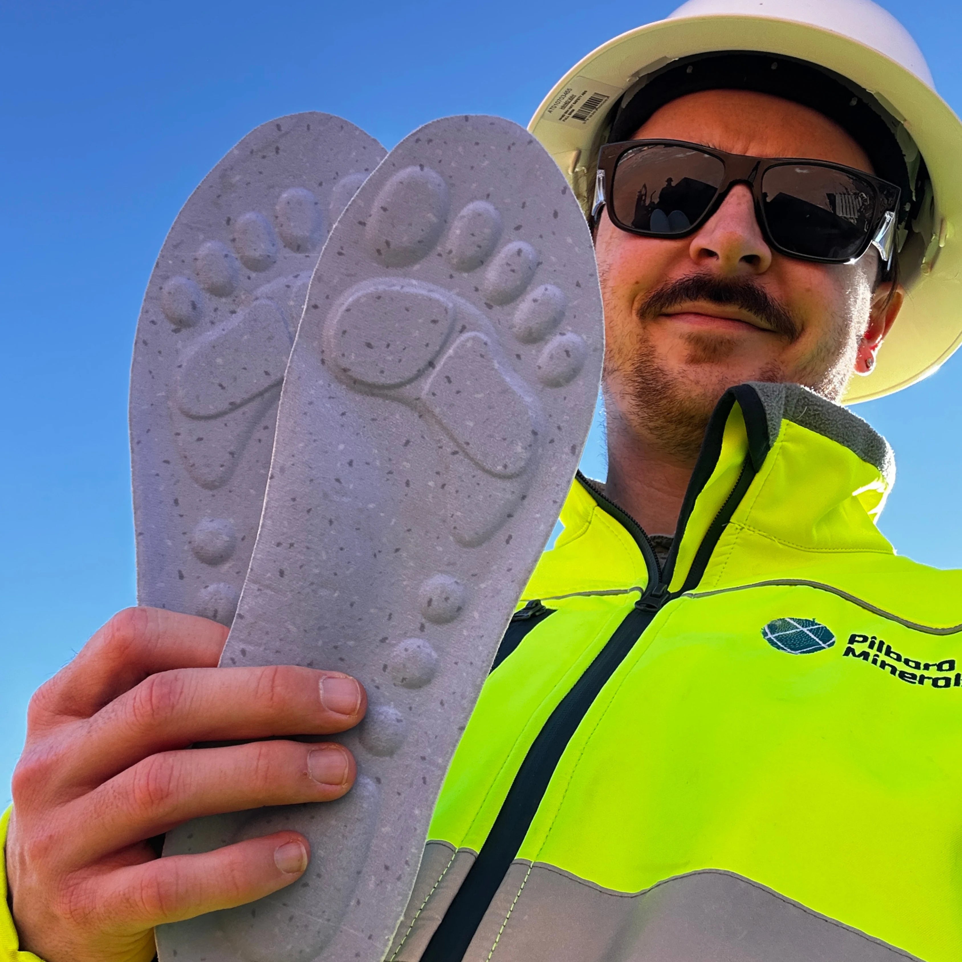 FIFO worker holding WorkFit insoles on site