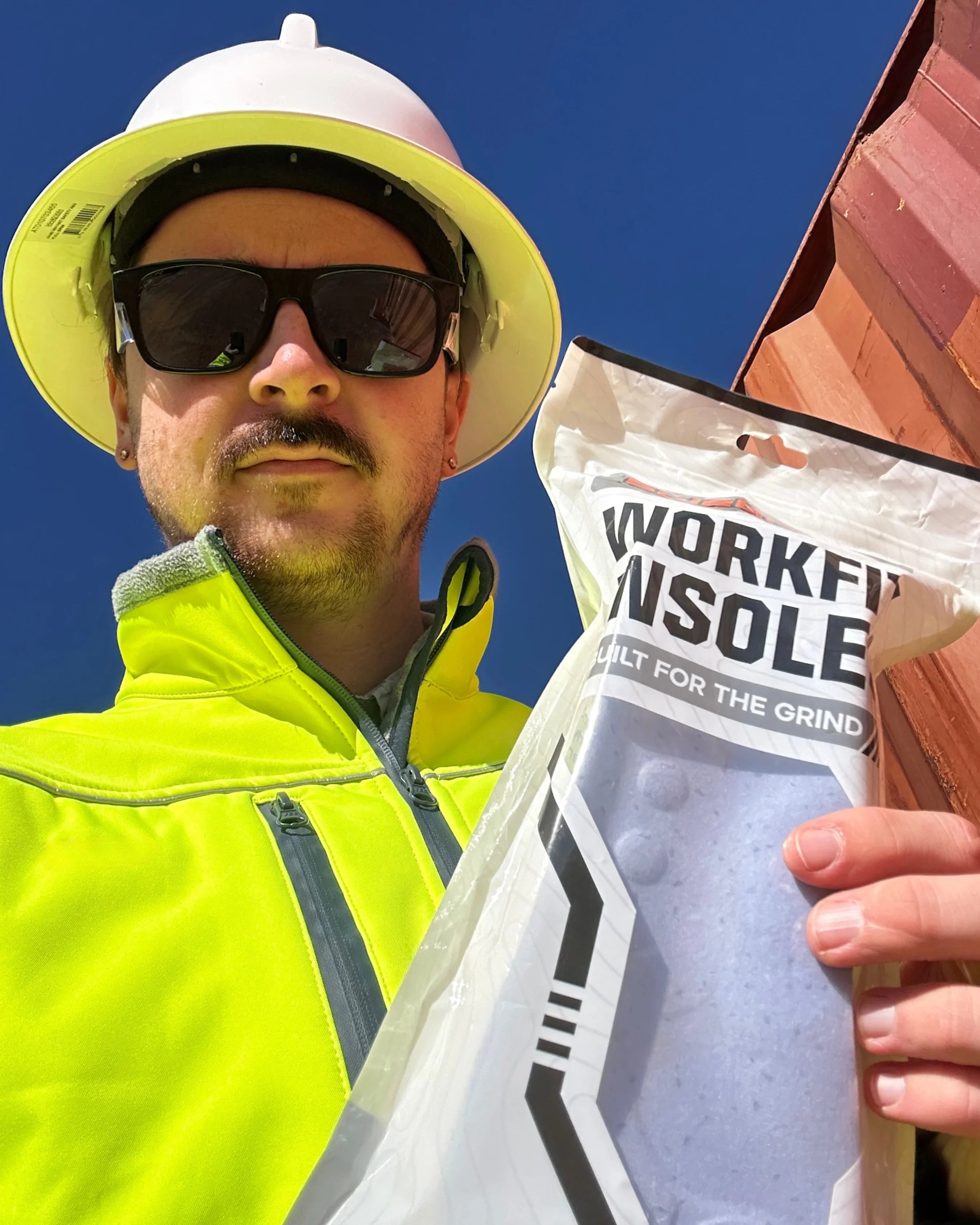 Worker holding the underside of WorkFit Insoles at a mine site